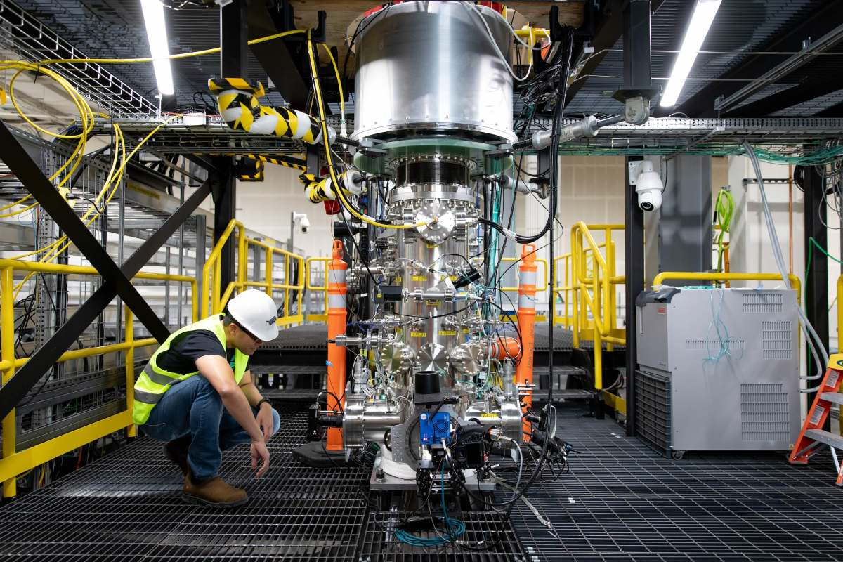 A worker inspects Zap Energy's Fusion reaction chamber.